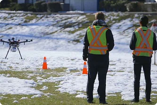 Community members training with a drone outdoors